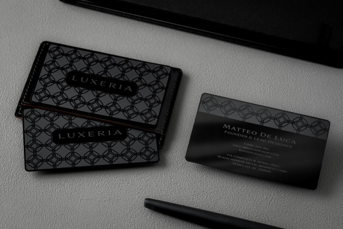 Luxury black metal business cards for Luxeria and Matteo De Luca with geometric pattern and mirror finish