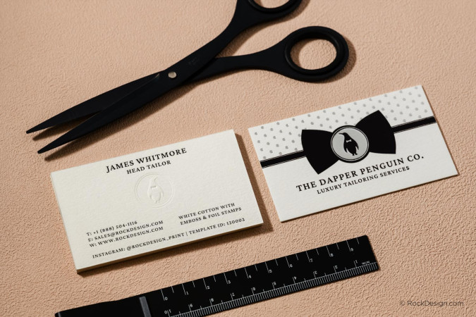 Custom cotton business cards with embossing, silver foil stamping and luxury print finishes on premium white cotton cardstock, displayed in a professional branding mockup.