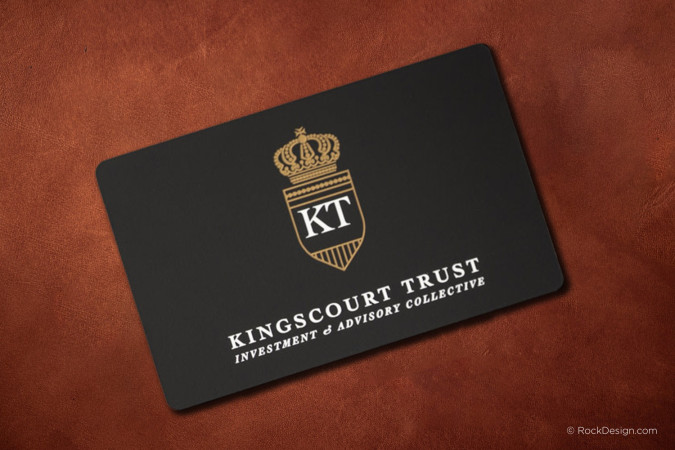 Luxury black suede metal business card with metallic gold etched crest and white spot color printing, featuring a premium soft-touch finish on a black metal card for luxury branding.