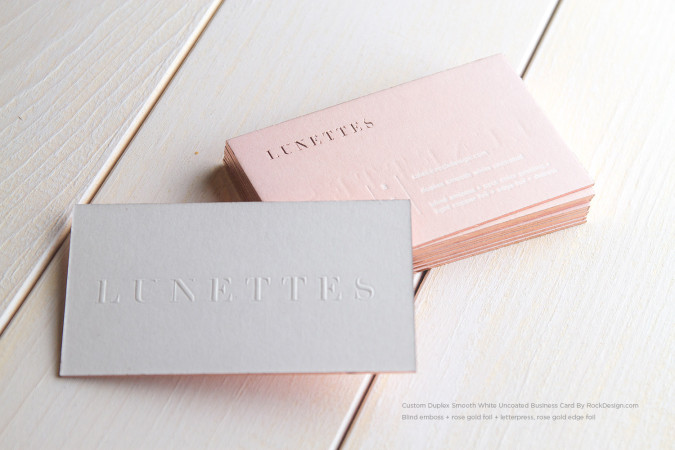 Luxury blind embossed business card on smooth white uncoated cardstock with rose gold foil edge painting and premium duplex paper construction.