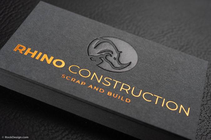 Black luxury business card with copper foil logo and embossed rhino design for Rhino Construction