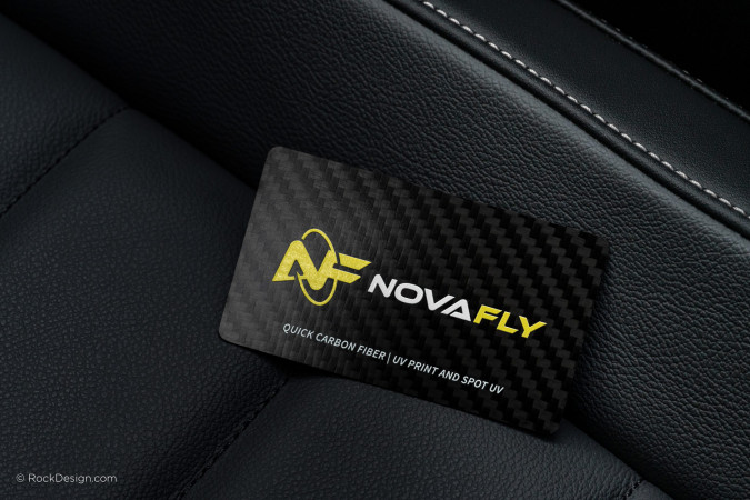 Carbon fiber business card with yellow and white UV print and spot UV logo for a modern professional design.