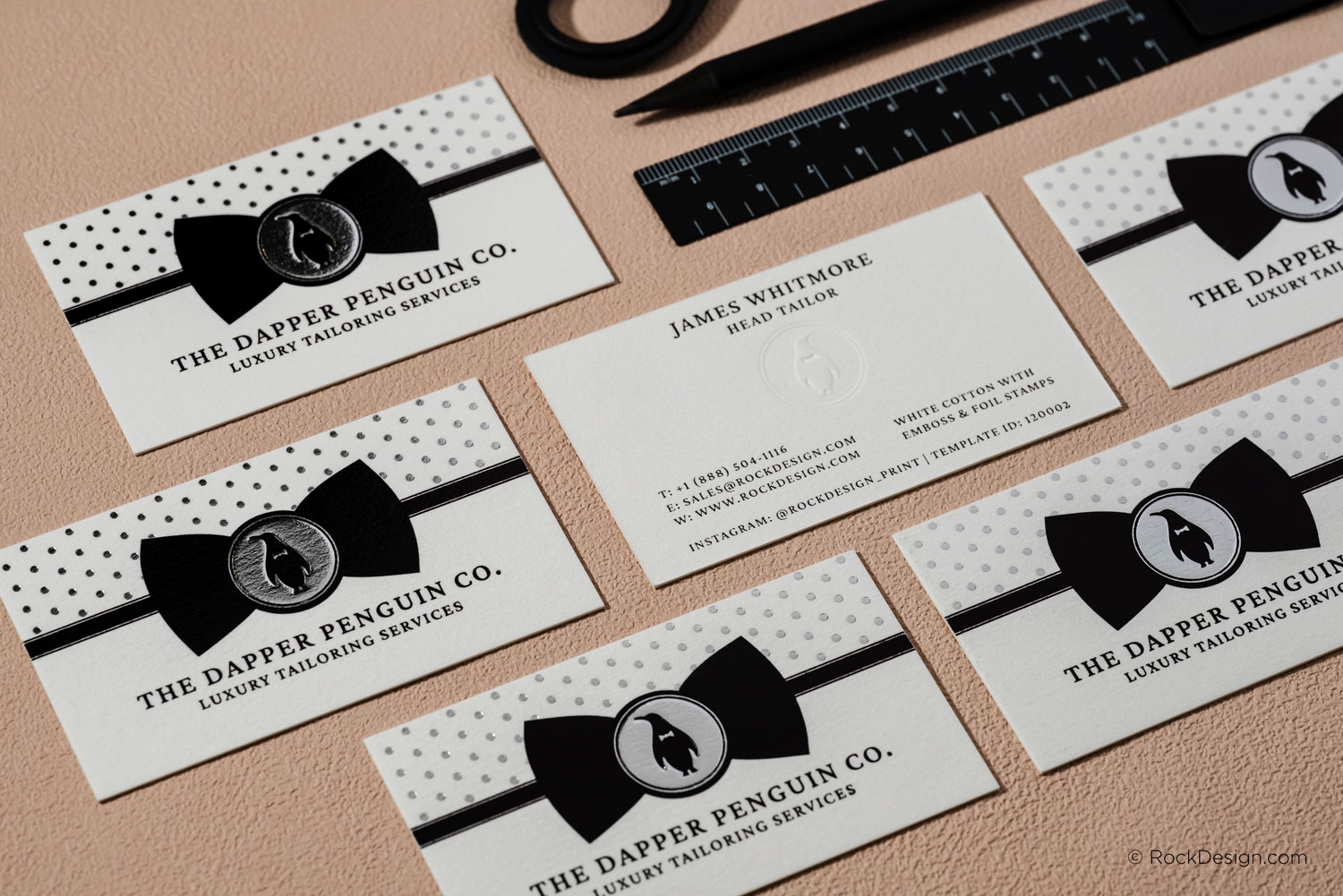 White cotton business cards with embossed logo, silver foil accents and premium luxury business card printing on thick 30pt textured cotton cardstock.
