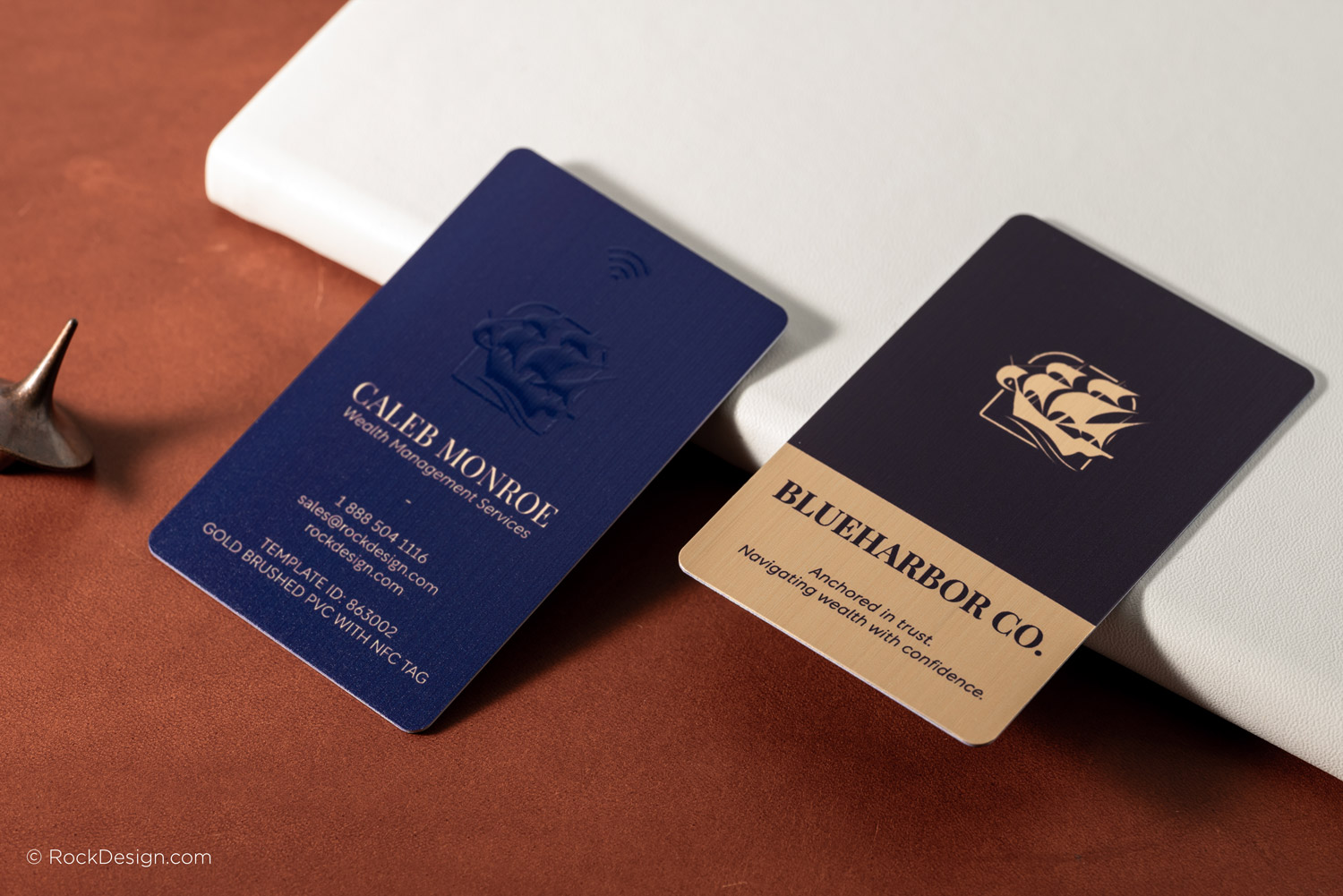 High-end brushed gold and navy blue PVC business cards with spot UV printing and embedded NFC tag for modern networking.